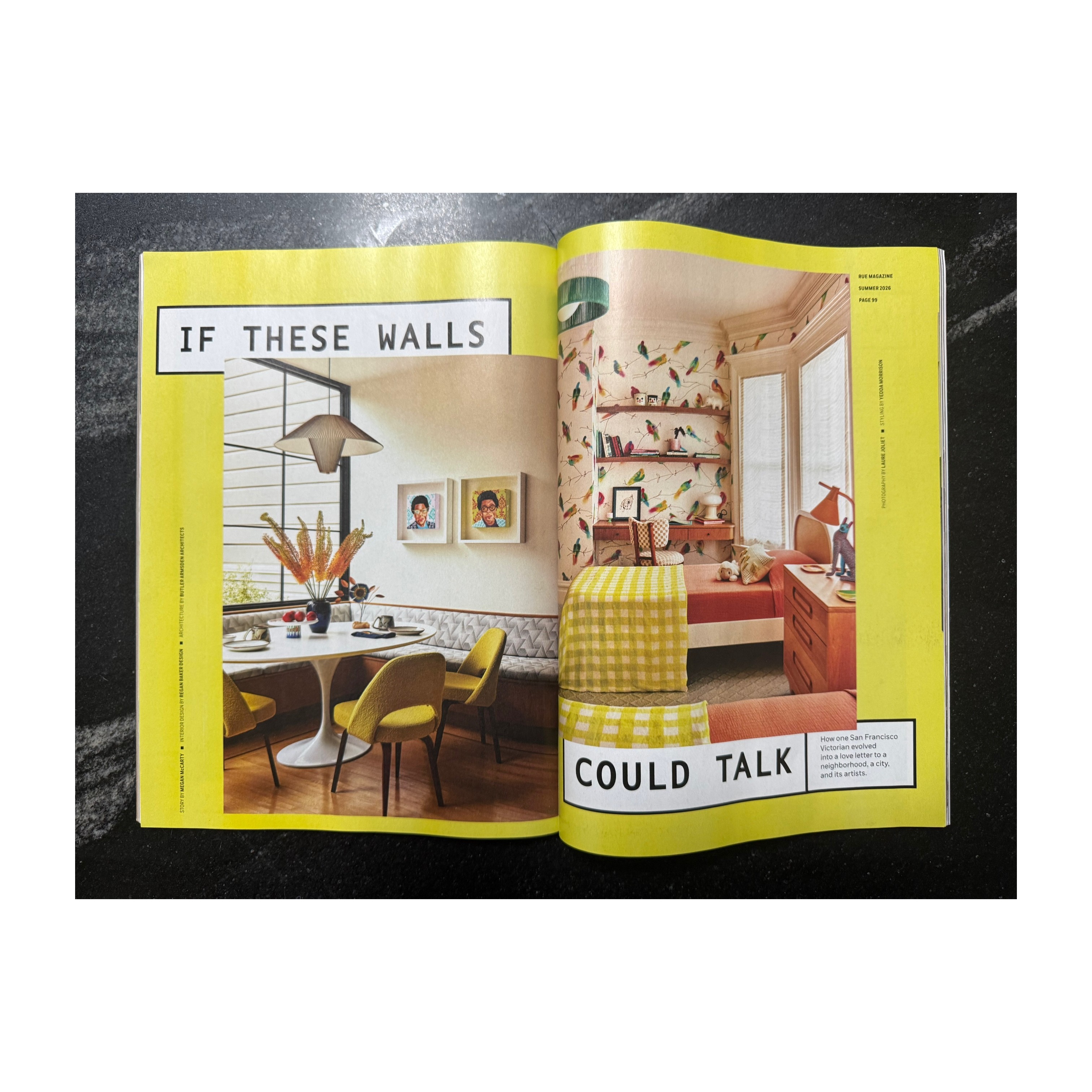 Open magazine showing a room with yellow walls, a dining table, and a cozy seating area with colorful decor.