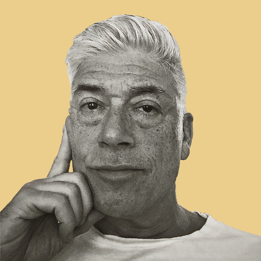 Black and white portrait of an older man with gray hair, resting his face on his hand, against a yellow background.